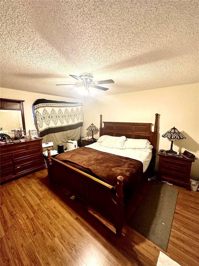 bedroom featuring a textured ceiling, ceiling fan, and wood-type flooring