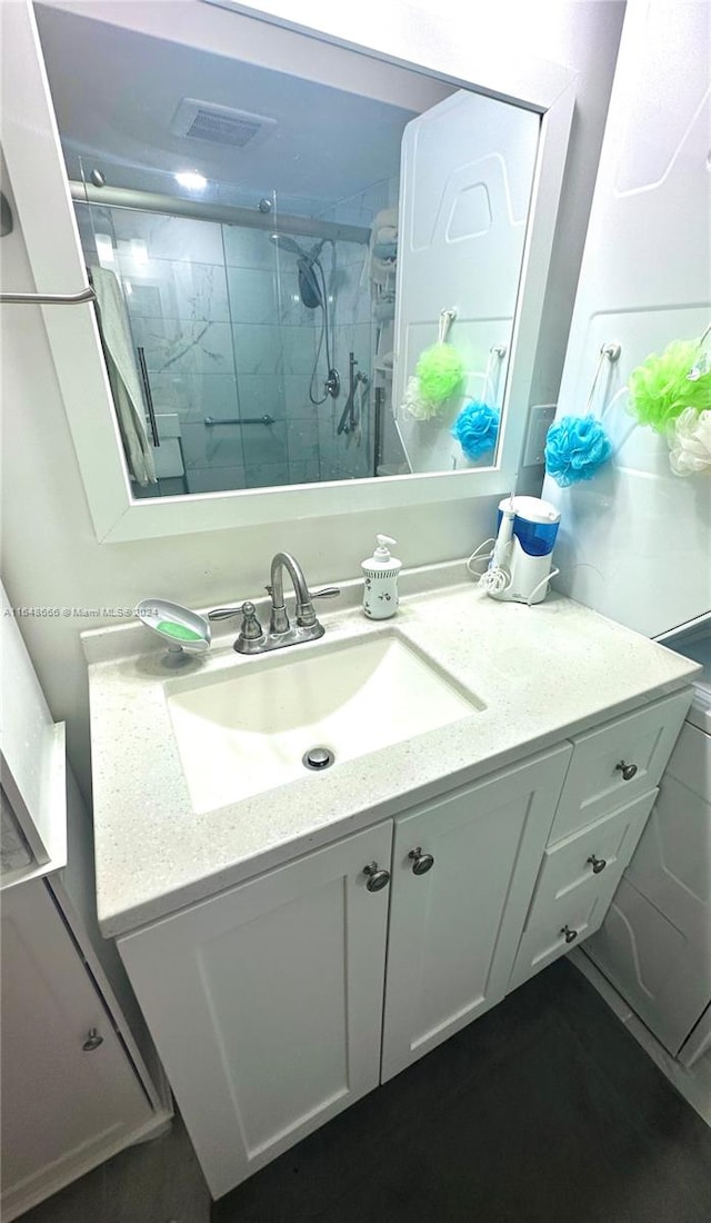 bathroom featuring an enclosed shower and vanity