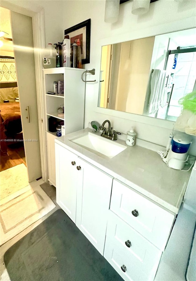 bathroom with hardwood / wood-style flooring and vanity