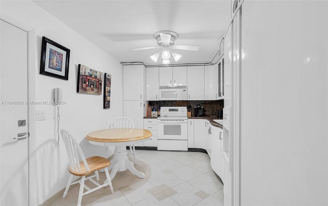 kitchen with white appliances, light tile patterned floors, decorative backsplash, ceiling fan, and white cabinets