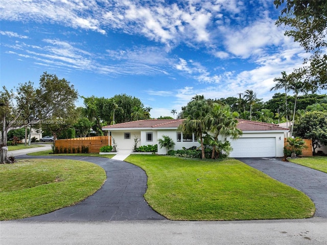 single story home featuring a garage and a front yard