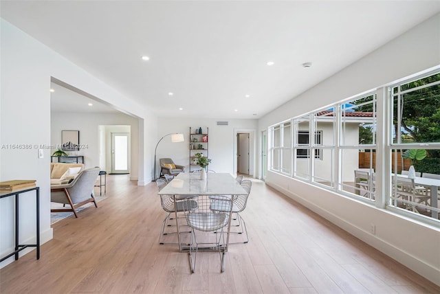 dining room with light hardwood / wood-style floors and a healthy amount of sunlight