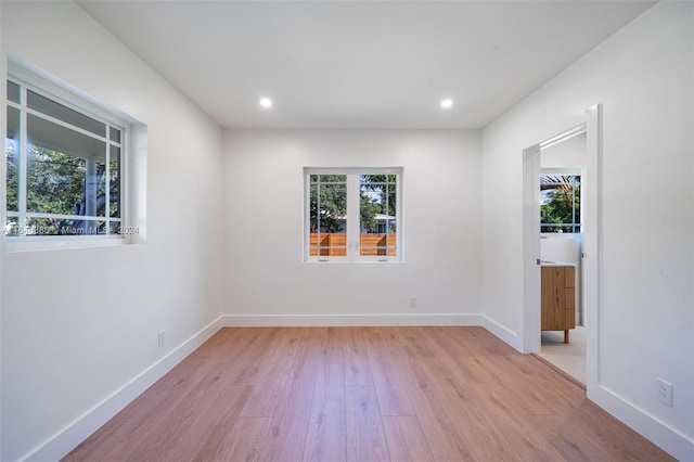 unfurnished room with light hardwood / wood-style flooring and a wealth of natural light