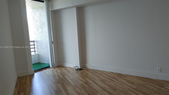 unfurnished room with wood-type flooring