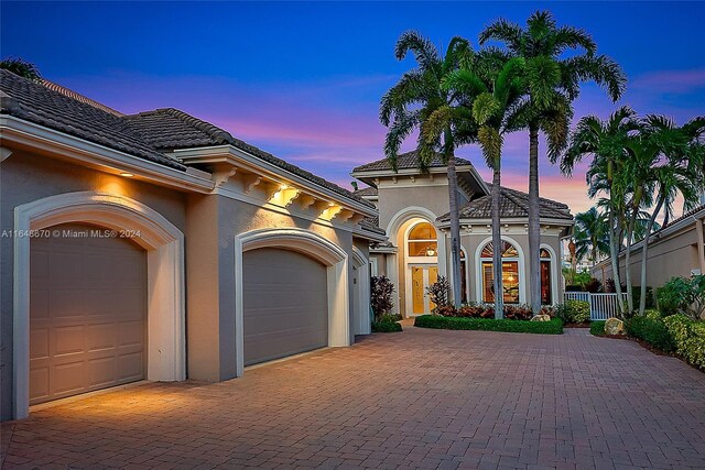 mediterranean / spanish home featuring a garage