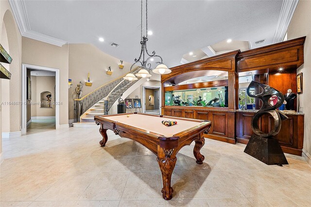 recreation room featuring billiards, light tile patterned flooring, and ornamental molding