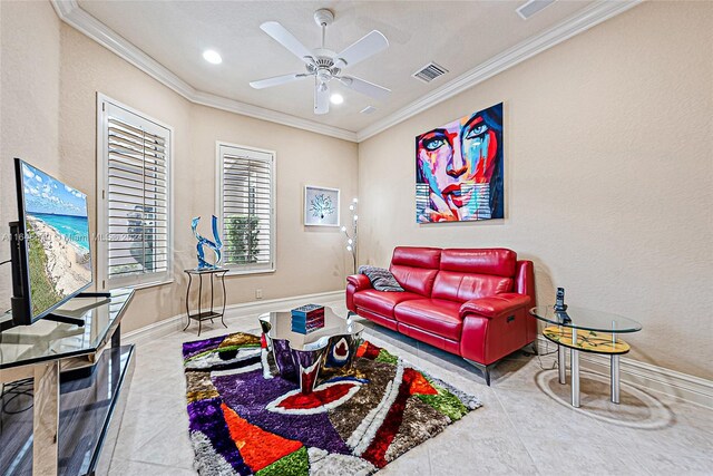 tiled living room with ceiling fan and crown molding