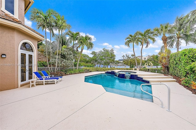 view of swimming pool with a patio and an in ground hot tub