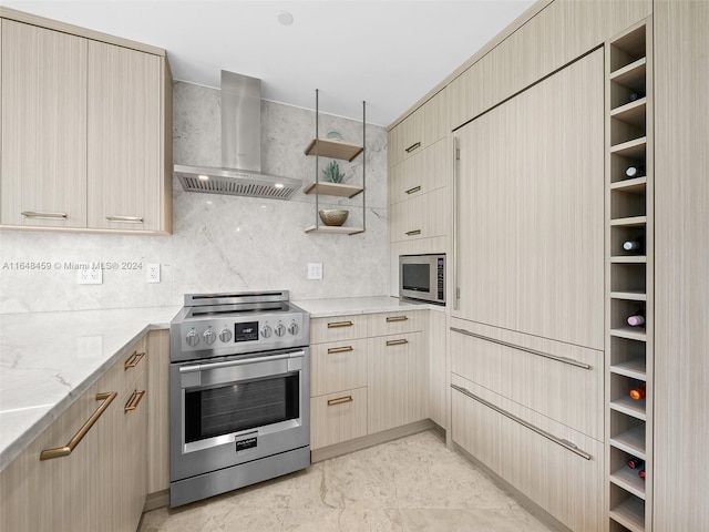 kitchen with tasteful backsplash, wall chimney exhaust hood, appliances with stainless steel finishes, light stone countertops, and light brown cabinetry