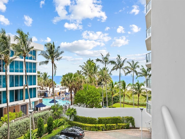 exterior space featuring a water view and a pool