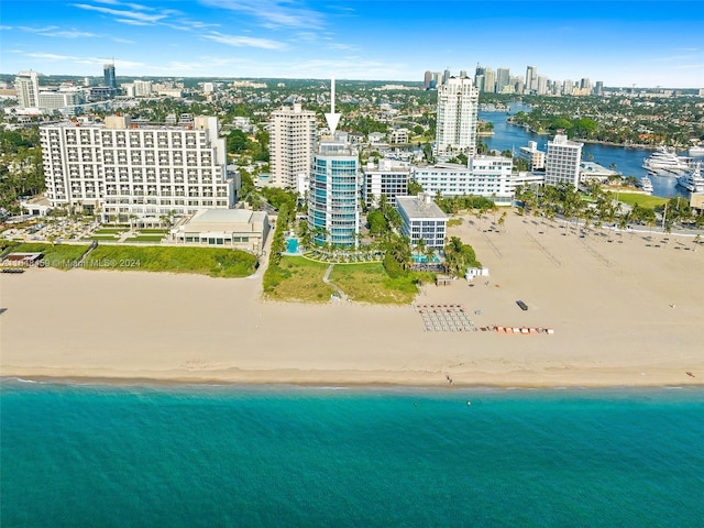 bird's eye view featuring a view of the beach and a water view