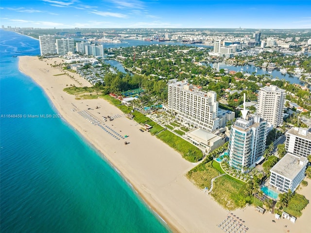 bird's eye view with a water view and a beach view