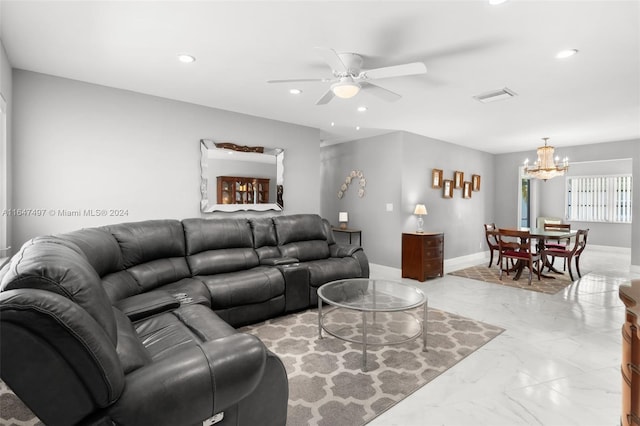 living room with ceiling fan with notable chandelier and light tile patterned floors