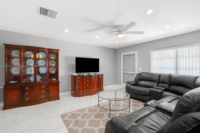 living room featuring ceiling fan and light tile patterned floors