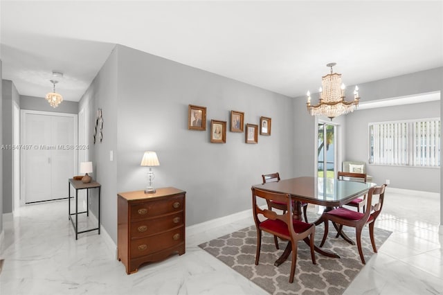 dining space featuring light tile patterned flooring and an inviting chandelier