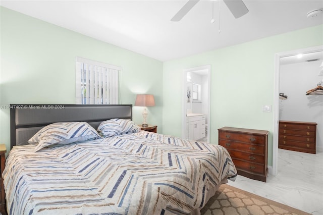 bedroom featuring ceiling fan, tile patterned flooring, and connected bathroom