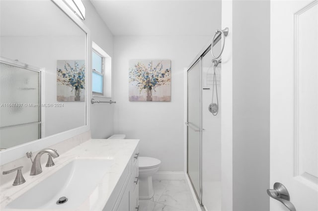 bathroom with tile patterned flooring, an enclosed shower, vanity, and toilet