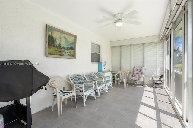 sunroom featuring ceiling fan