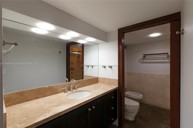 bathroom featuring toilet, tile patterned flooring, an enclosed shower, vanity, and a bidet