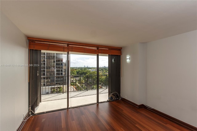 empty room with dark hardwood / wood-style flooring