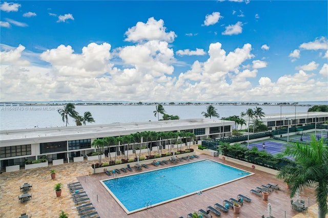 view of swimming pool featuring a water view