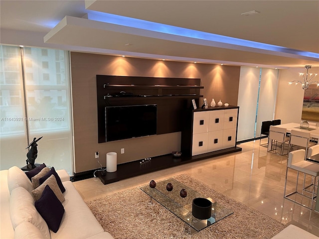 living room with an inviting chandelier and light tile patterned floors