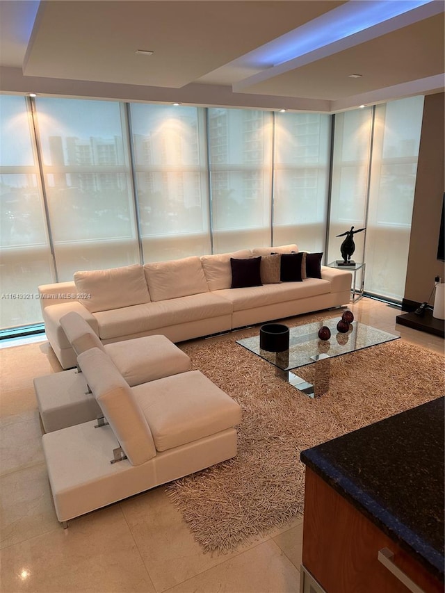 living room featuring plenty of natural light, light tile patterned floors, and expansive windows