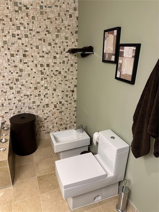 bathroom with tile walls and toilet