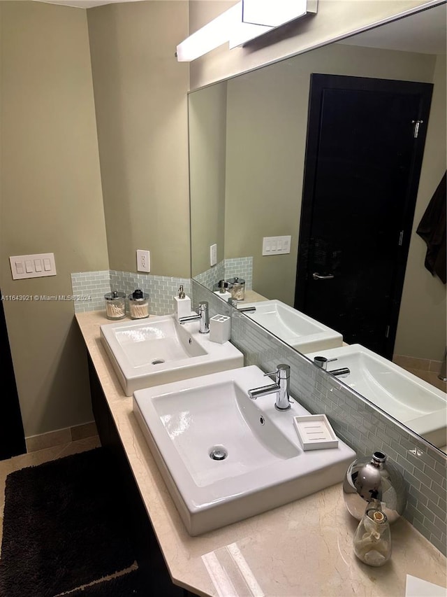 bathroom with a skylight, vanity, and tasteful backsplash