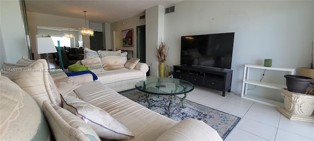 living room with an inviting chandelier and light tile patterned floors