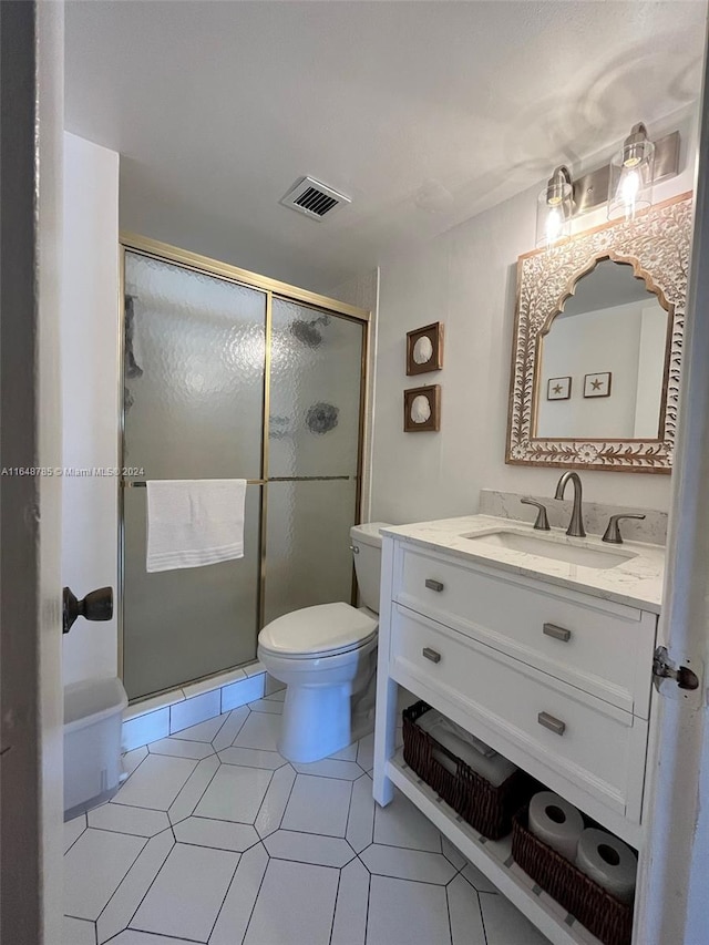 bathroom featuring tile patterned floors, toilet, walk in shower, and vanity