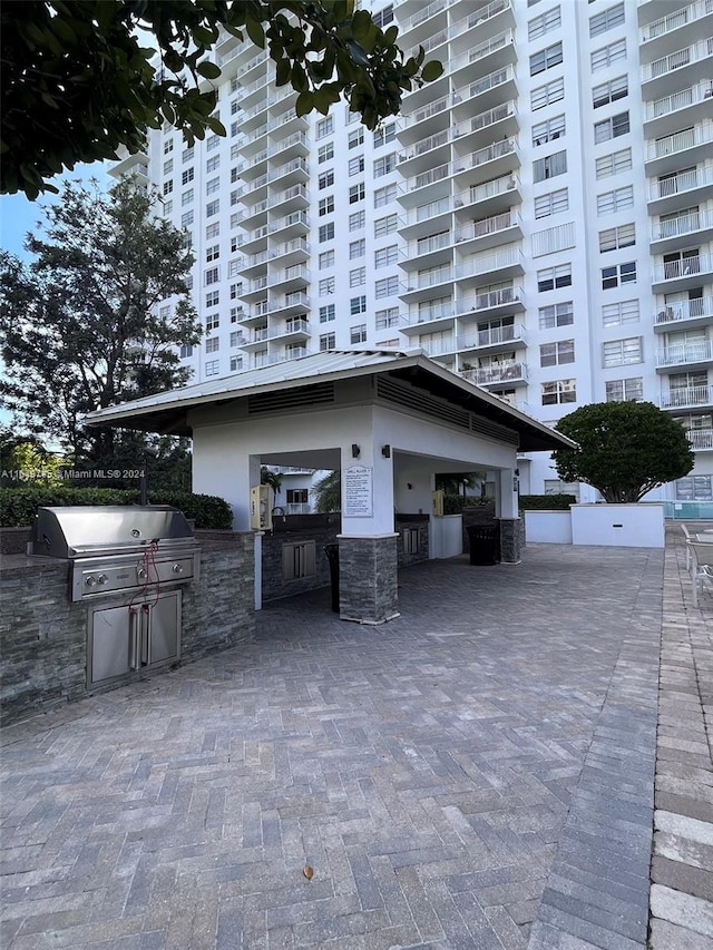 exterior space with a bar, a balcony, and area for grilling