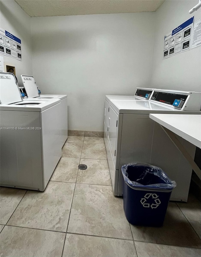 washroom featuring washer and dryer and light tile patterned floors