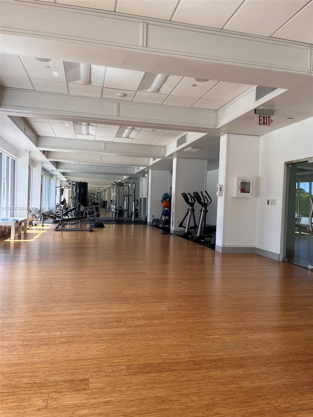 exercise room with wood-type flooring