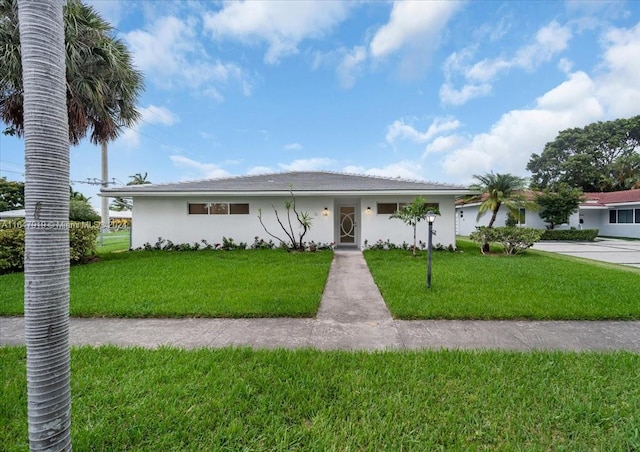 ranch-style home with a front lawn