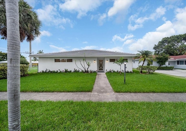 150 SE 3rd Ave, Dania Beach, FL 33004 - ranch-style house featuring a front yard and stucco siding
