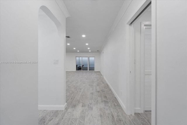150 SE 3rd Ave, Dania Beach, FL 33004 - hallway featuring light wood-style flooring, recessed lighting, arched walkways, and ornamental molding