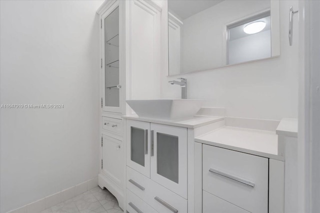 150 SE 3rd Ave, Dania Beach, FL 33004 - kitchen featuring glass insert cabinets, light countertops, and white cabinets