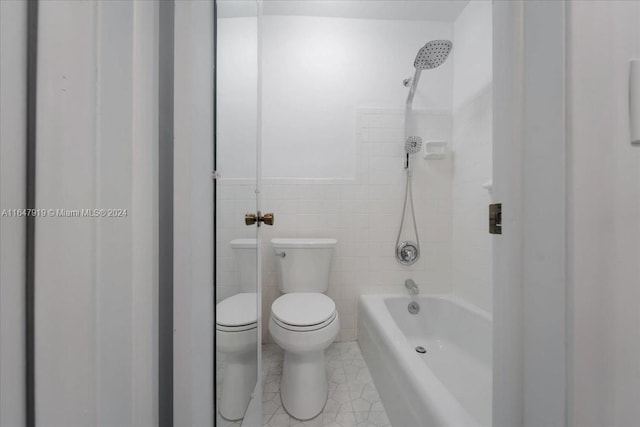 150 SE 3rd Ave, Dania Beach, FL 33004 - full bathroom featuring bathing tub / shower combination, tile walls, and tile patterned flooring