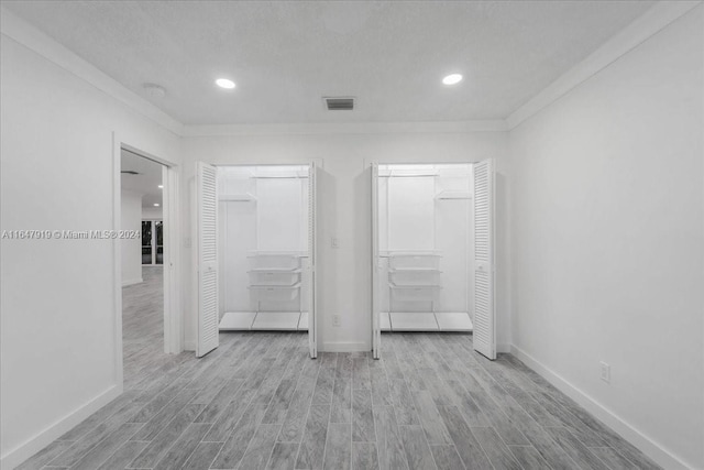 150 SE 3rd Ave, Dania Beach, FL 33004 - unfurnished bedroom with wood finished floors, recessed lighting, and ornamental molding