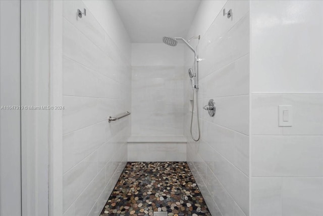 bathroom with tiled shower