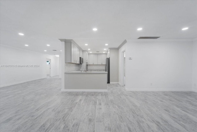 150 SE 3rd Ave, Dania Beach, FL 33004 - unfurnished living room with recessed lighting, light wood-style floors, and crown molding