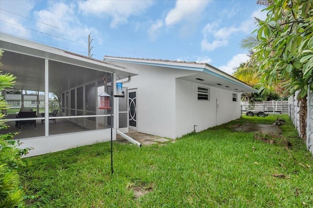 150 SE 3rd Ave, Dania Beach, FL 33004 - rear view of property with stucco siding and a sunroom