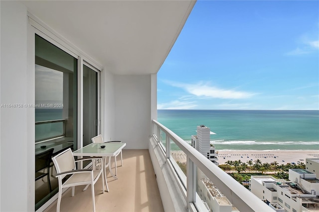 balcony with a view of the beach and a water view