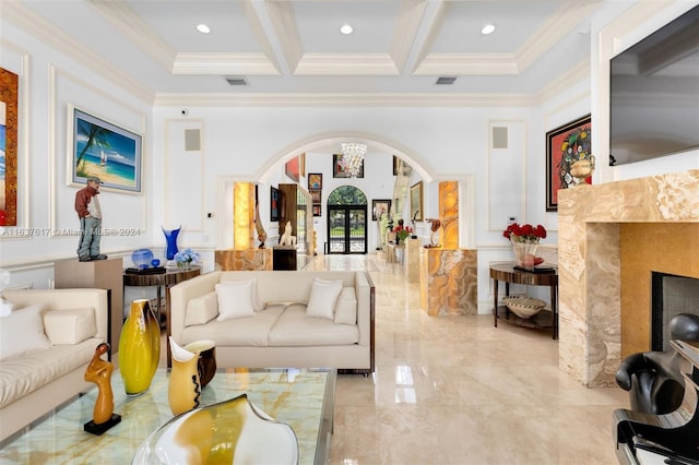 living room with beam ceiling, light tile patterned flooring, ornamental molding, and coffered ceiling