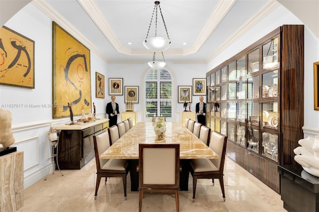 tiled dining space with a raised ceiling