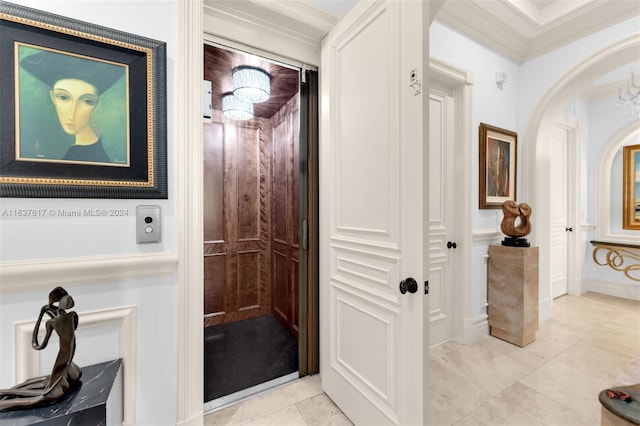 hallway featuring ornamental molding and light tile patterned floors