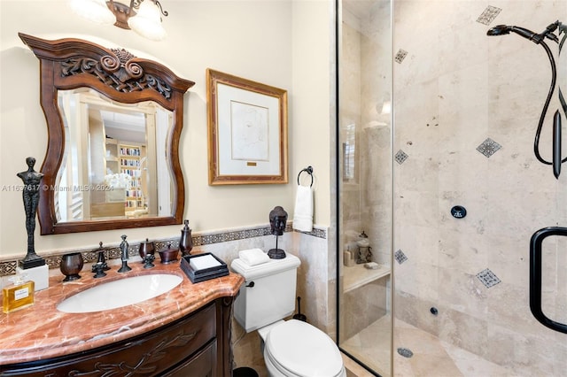 bathroom with an enclosed shower, vanity, and toilet