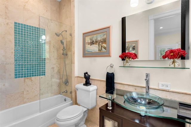 full bathroom with vanity, tiled shower / bath combo, and toilet