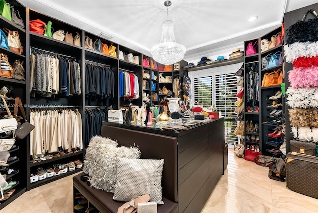 walk in closet featuring light tile patterned flooring and a chandelier